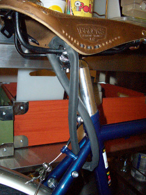 A Brooks saddle secured by a bike chain seat lock
